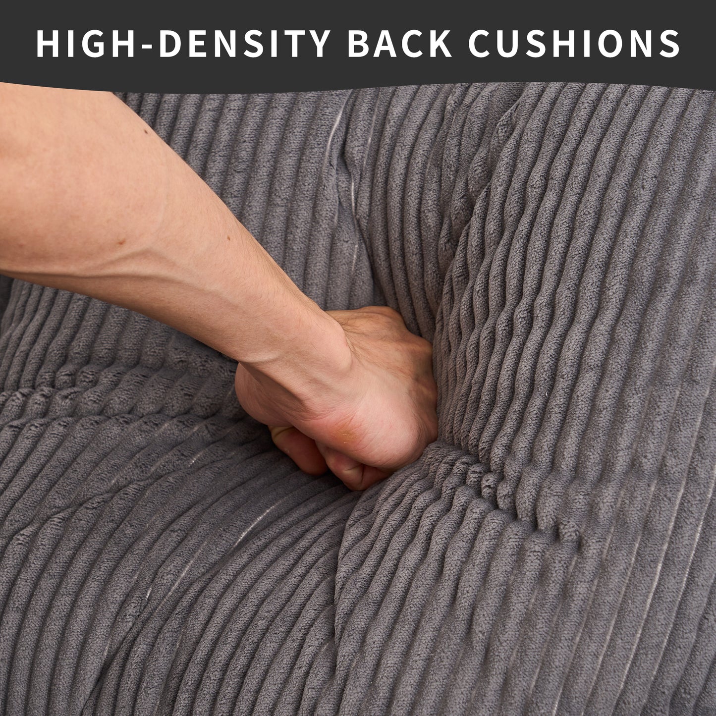 Hand pressing into a plush gray corduroy sofa cushion highlighting its highdensity comfort