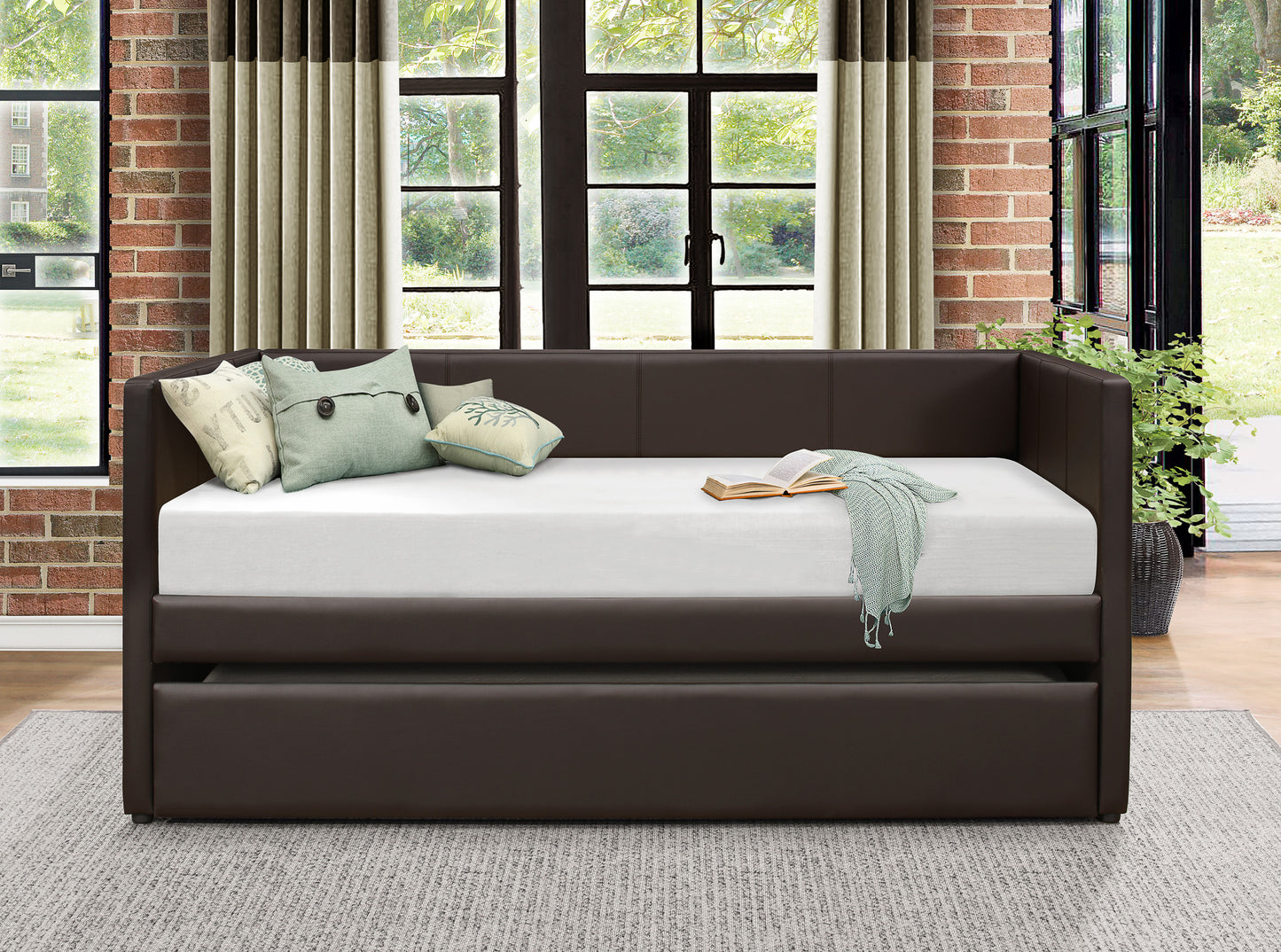 Dark brown faux leather daybed with pullout trundle and throw pillows