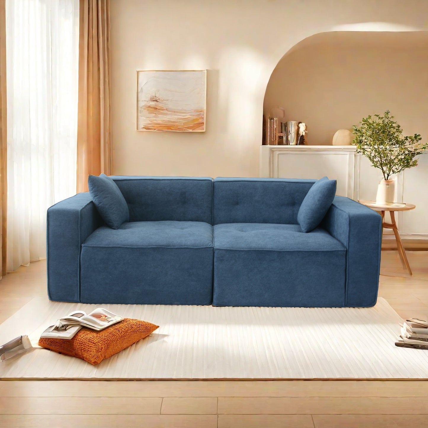 Modern blue fabric sectional sofa with two toss pillows and tufted cushions