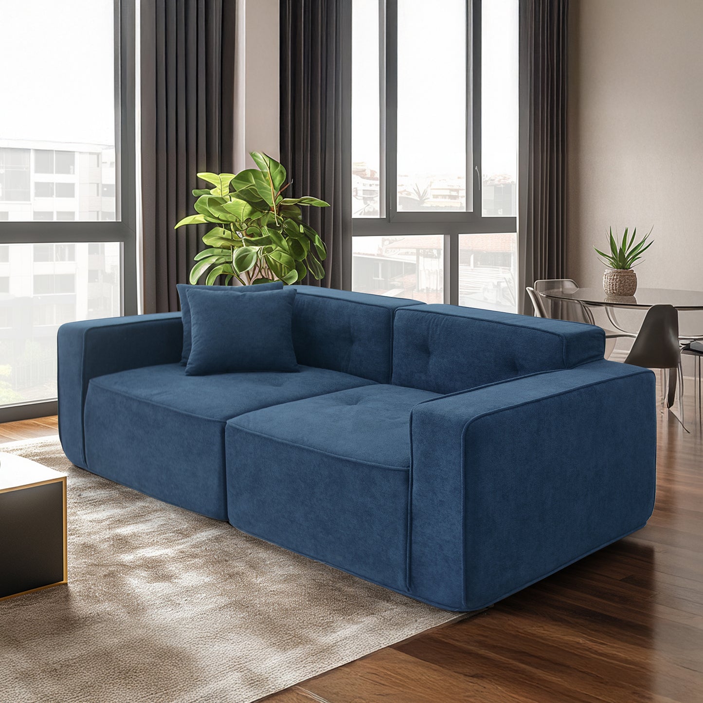 Deep blue velvet modular sofa with a modern square design and matching accent pillow