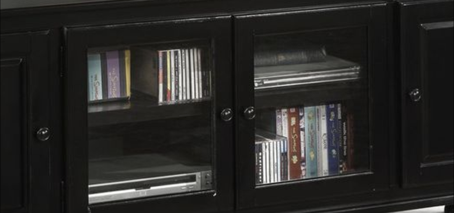 Black media cabinet with glass doors storing CDs and DVDs neatly on shelves