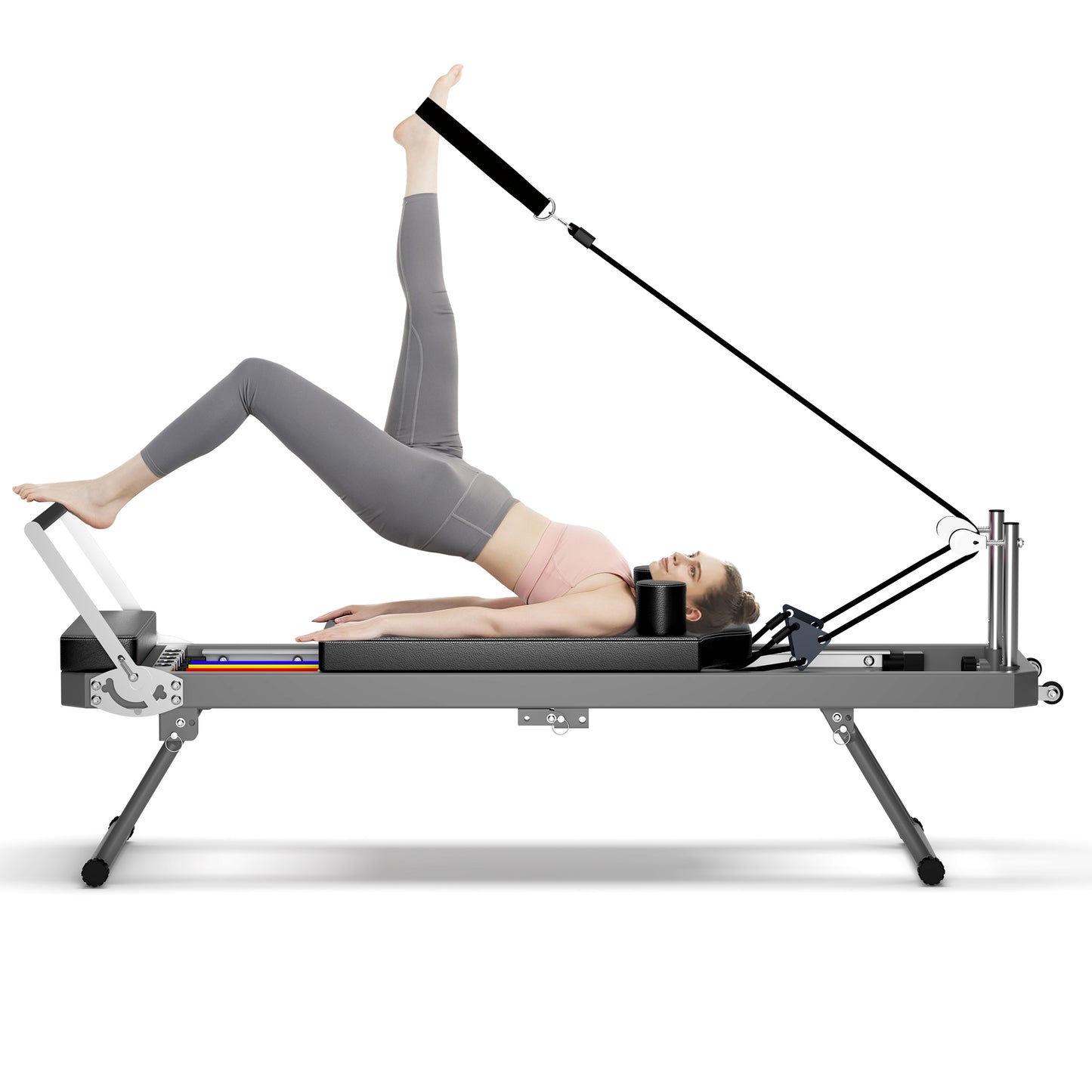 Woman performing a leg extension exercise on a grey pilates reformer machine