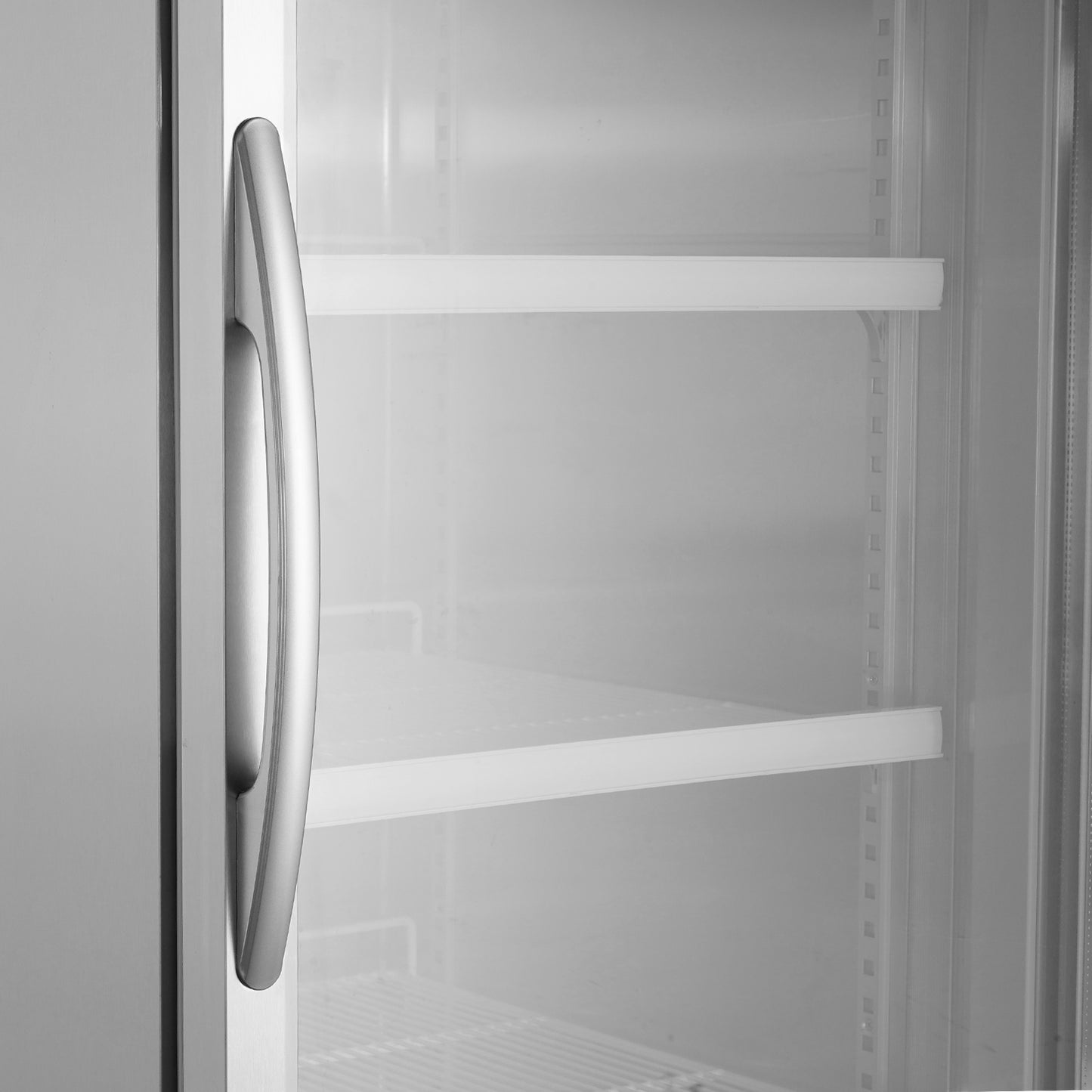 Stainless steel refrigerator door handle with visible shelves inside a commercial cooler