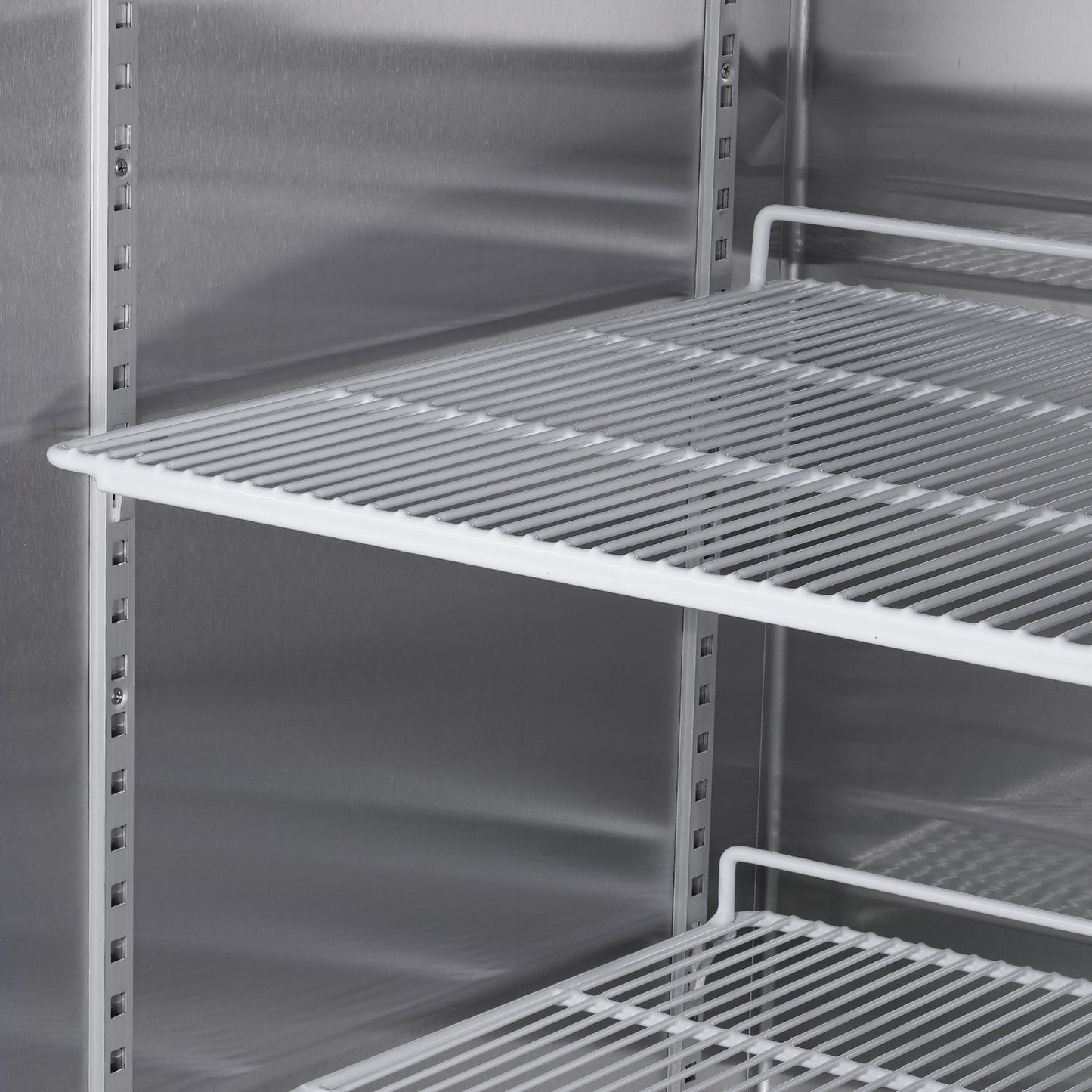 Stainless steel commercial refrigerator interior with wire shelves