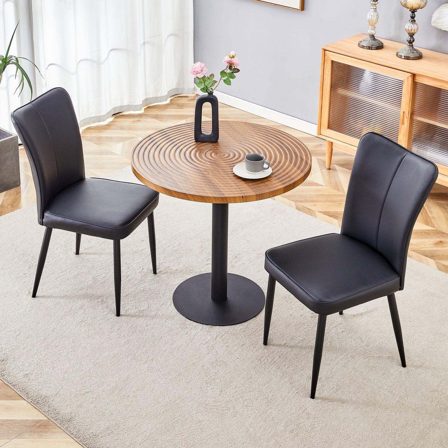 Black faux leather dining chair with slim metal legs ideal for modern kitchens