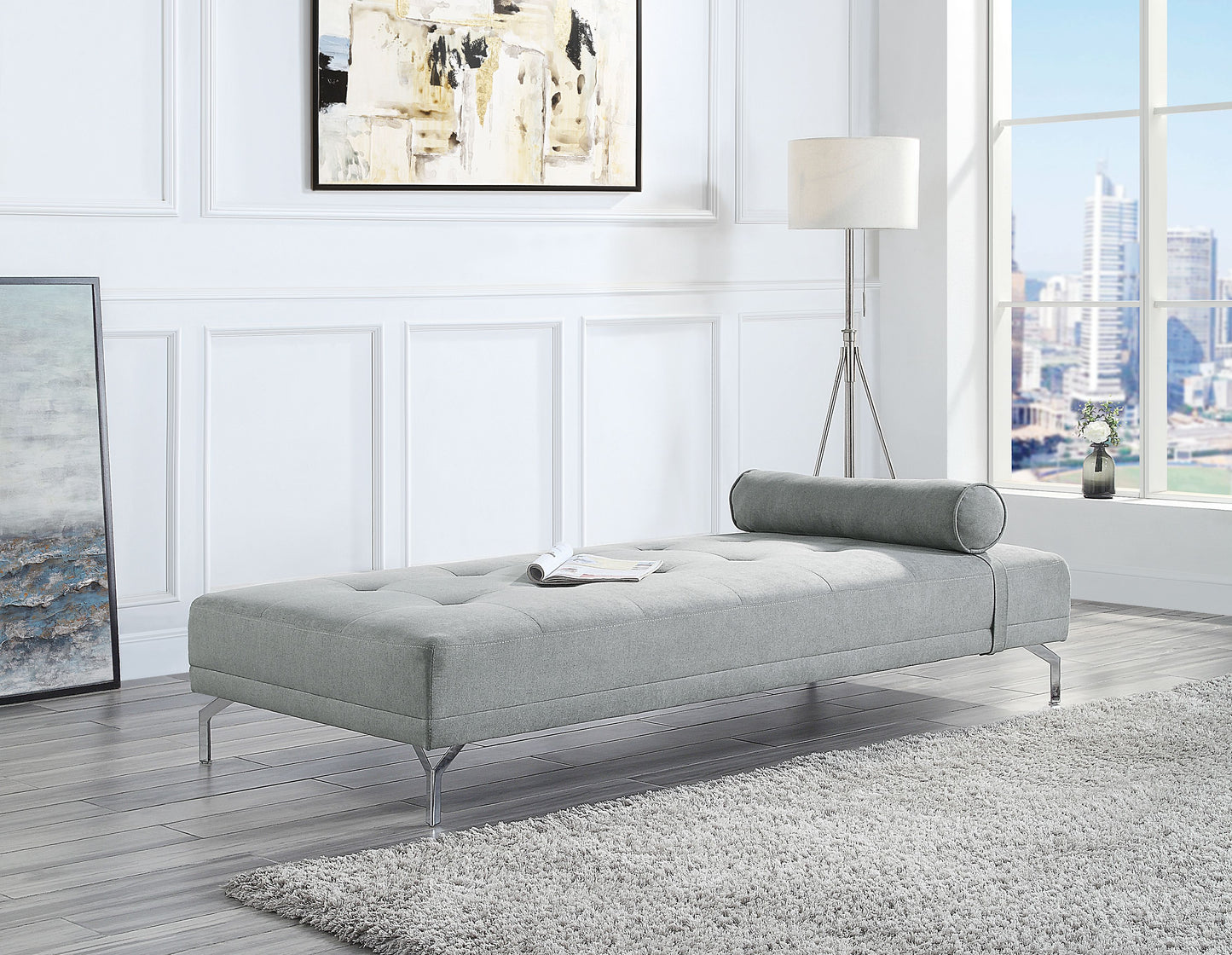 Tufted grey fabric chaise lounge with cylindrical bolster pillow and chrome legs