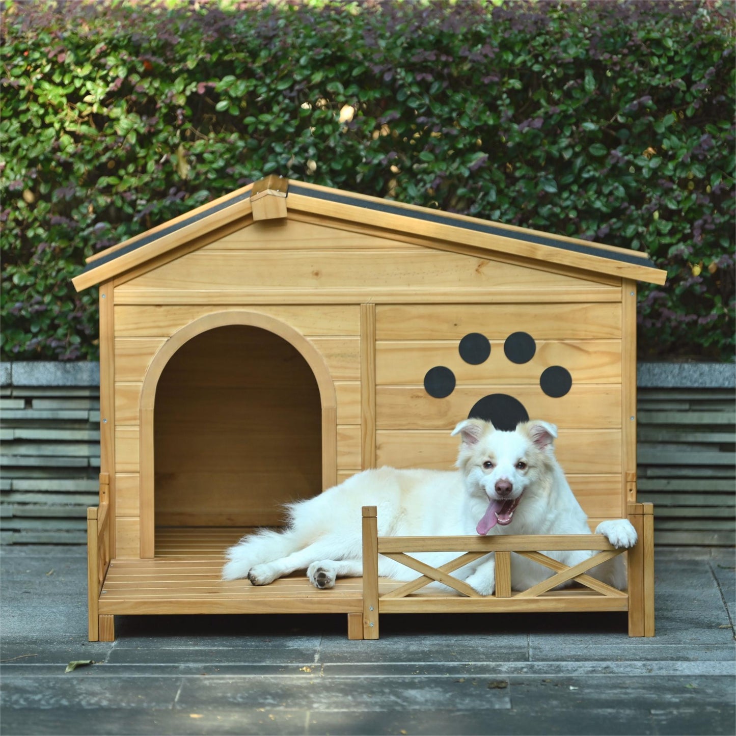 Natural wood dog house with an attached porch and a happy dog relaxing