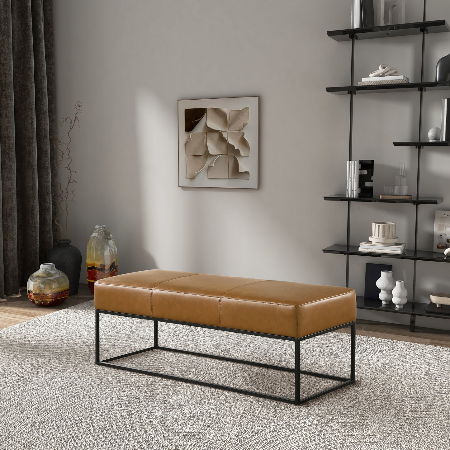 Tan leather bench with quilted detail and black metal frame