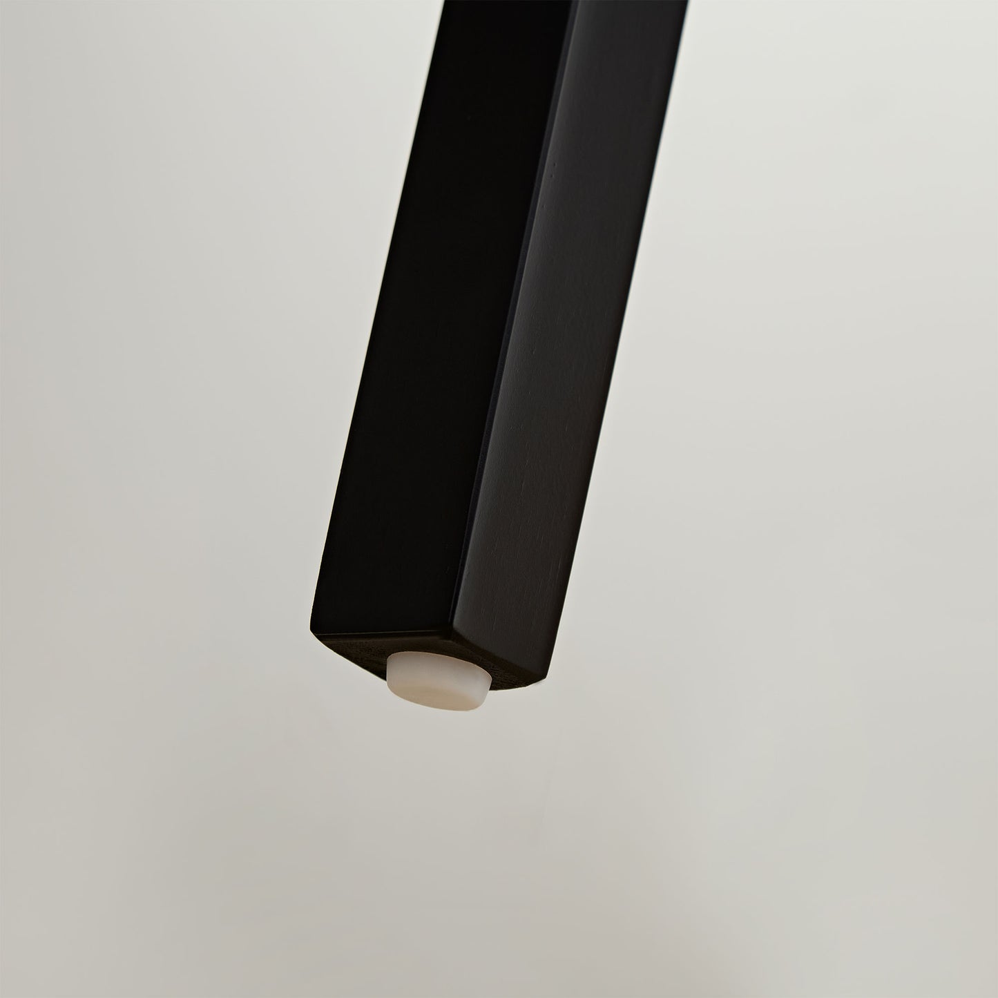 Black tapered furniture leg with protective floor pad