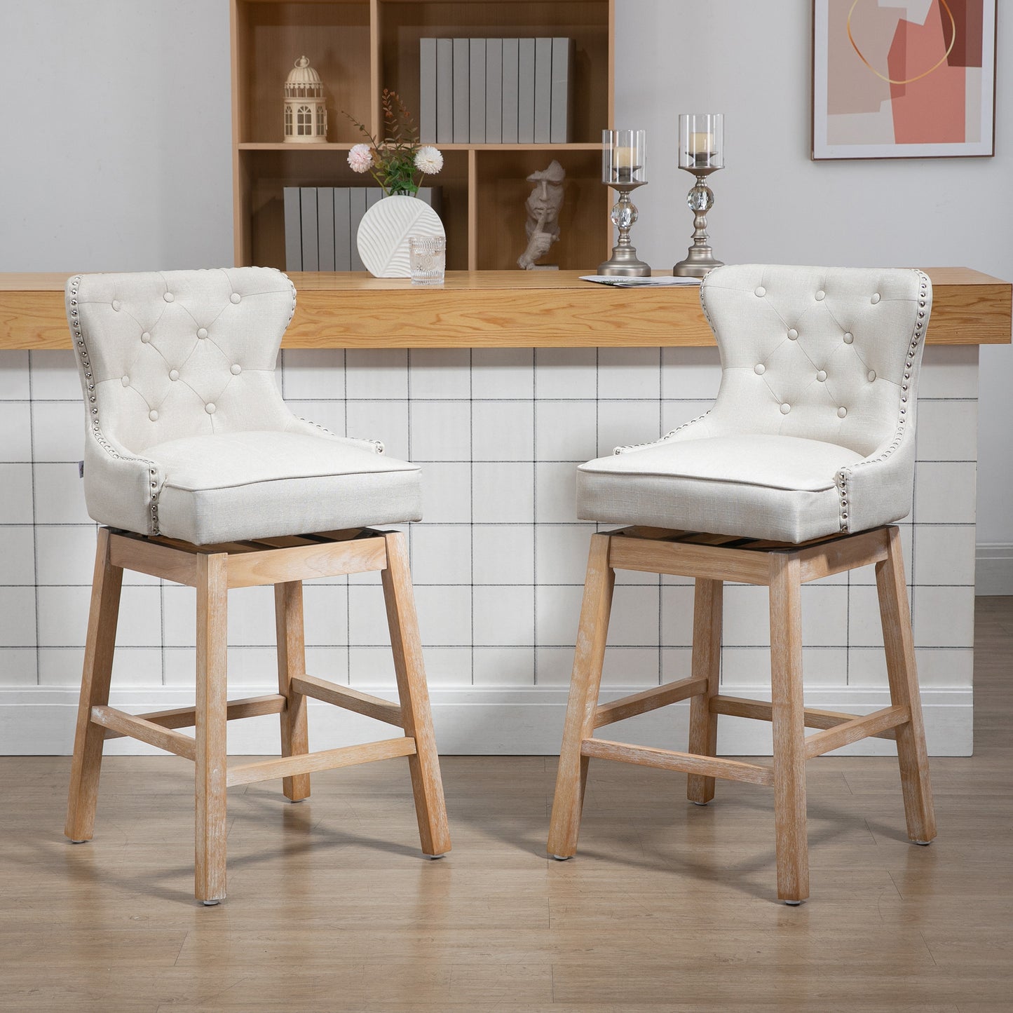 Cream upholstered bar stool with tufted back and silver nailhead trim