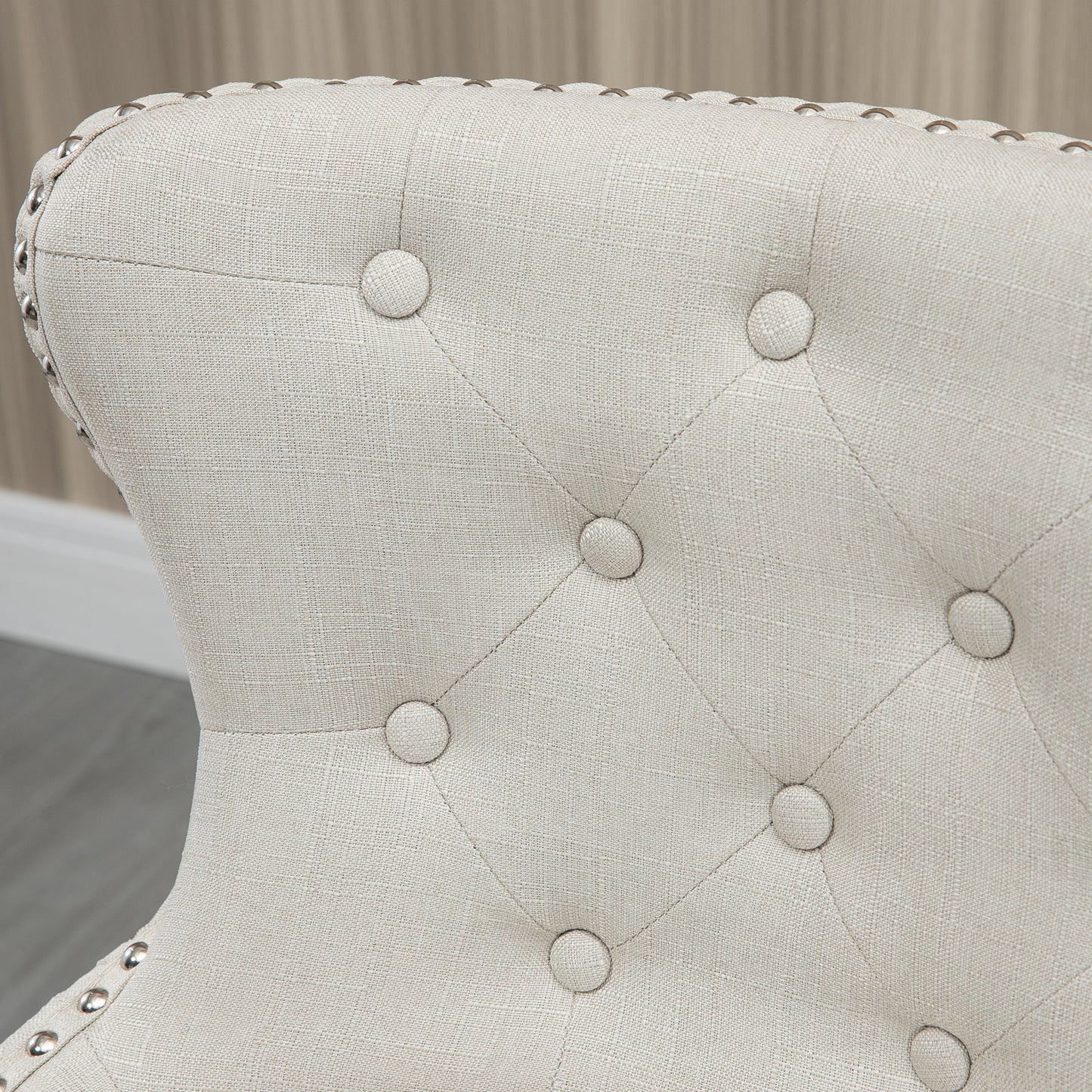 Tufted beige linen accent chair with silver nailhead trim detailing