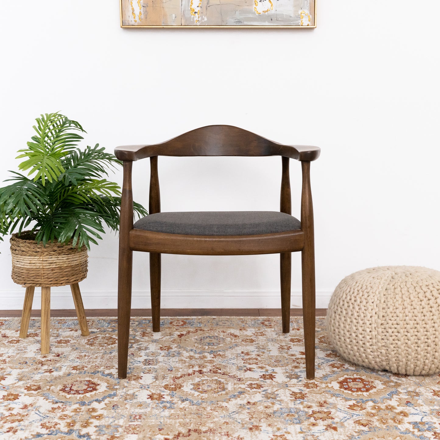 Dark wood dining chair with grey cushioned seat and curved backrest