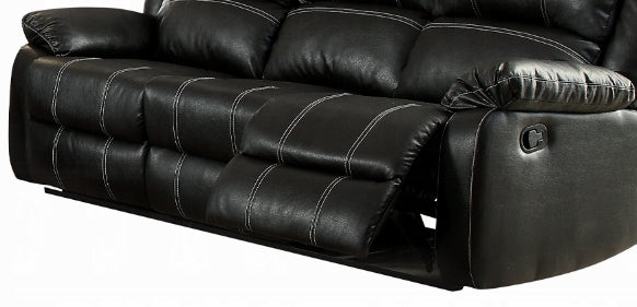 Black faux leather reclining sofa with white stitching and manual lever