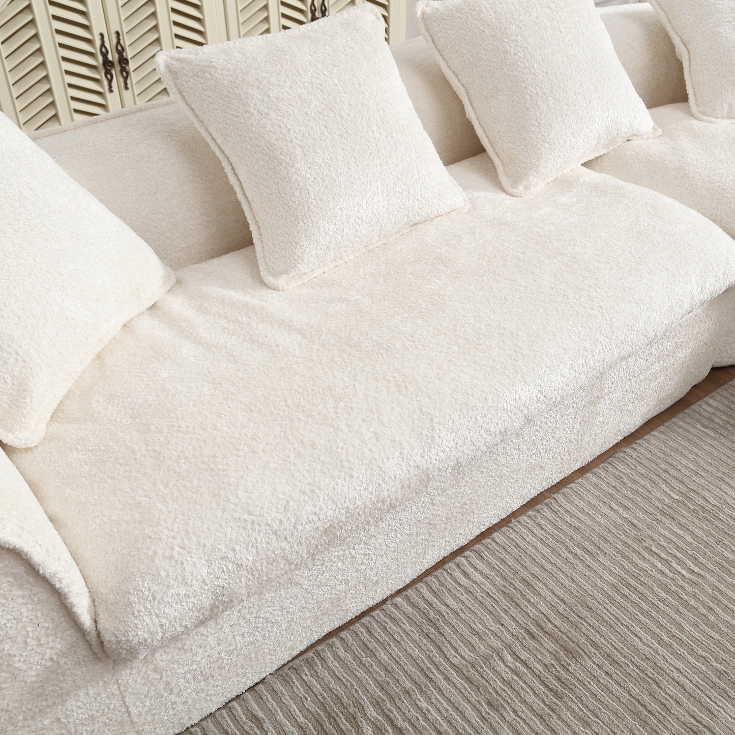 Plush cream boucle sofa with deep seats and throw pillows perfect for a cozy living room
