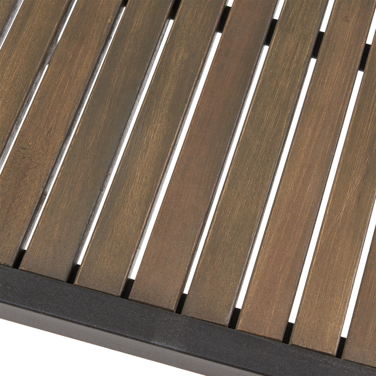 Closeup of brown slatted wood tabletop on a black metal frame