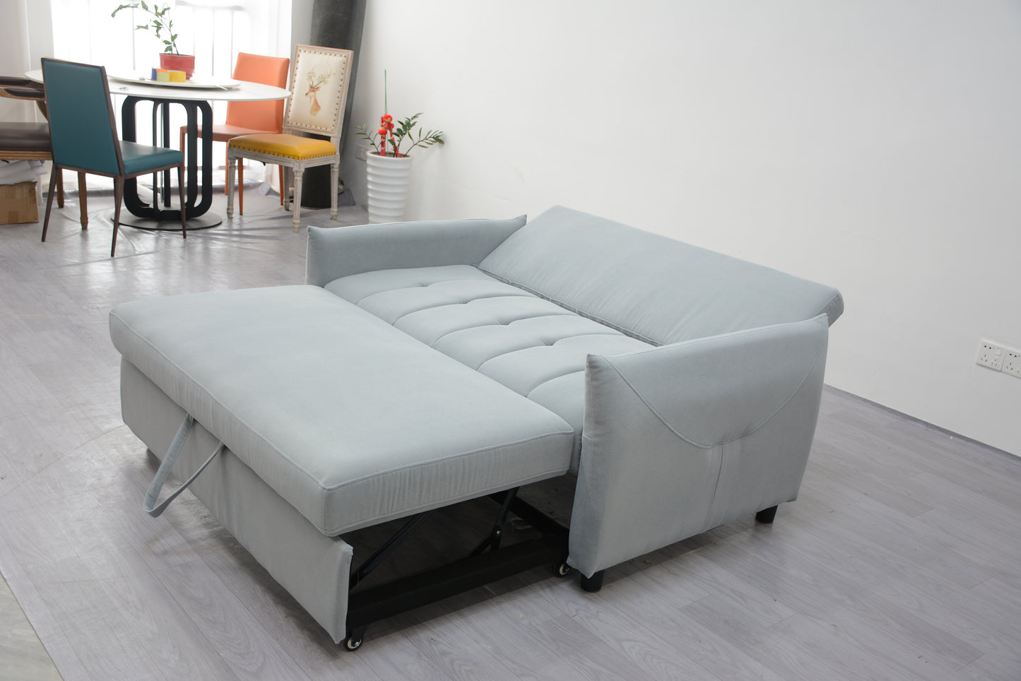 Light gray fabric sofa bed with pullout ottoman versatile for any living space
