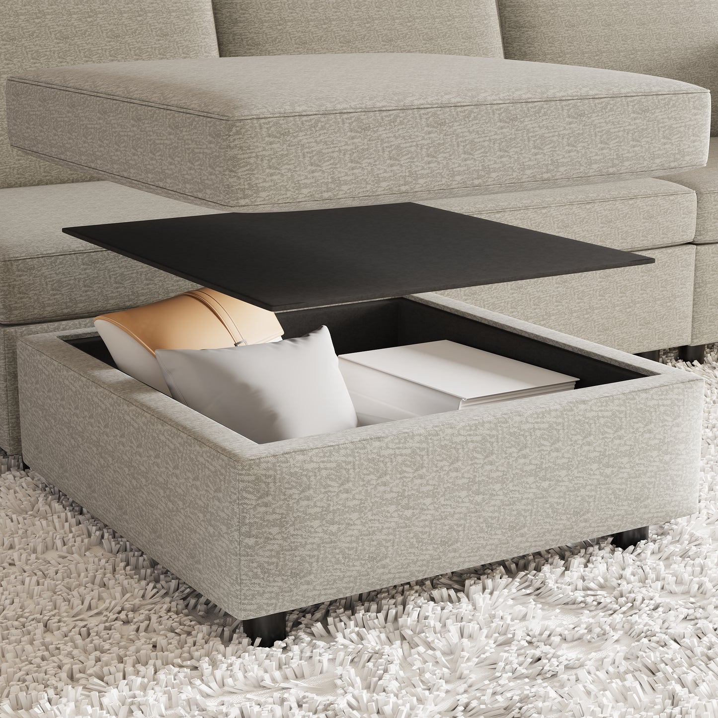 Light gray upholstered ottoman with open storage revealing pillows and books