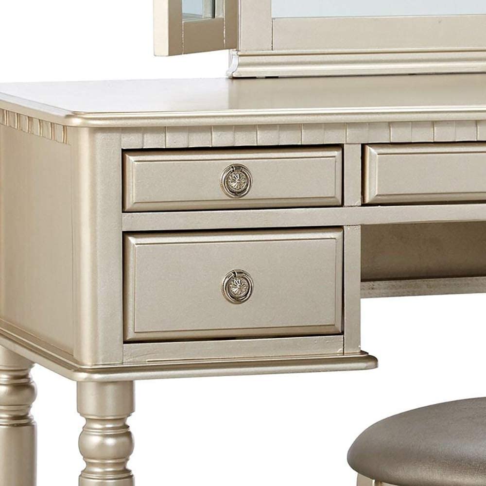 Champagne gold vanity dresser with decorative knobs and drawer fronts