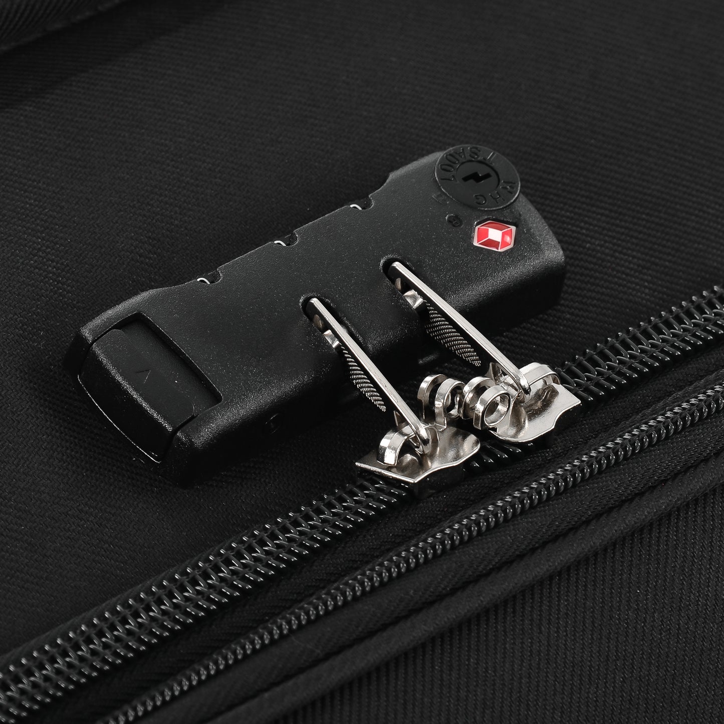 Black fabric luggage with TSAapproved combination lock and zipper pulls