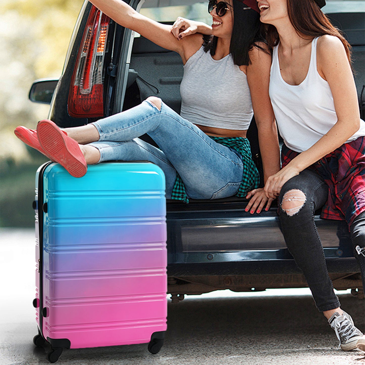 Gradient pink and blue hardshell spinner suitcase with wheels ready for travel