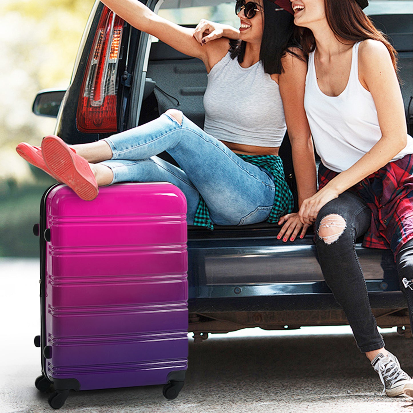Hardshell rolling suitcase with gradient pink to purple ombre ideal for travel
