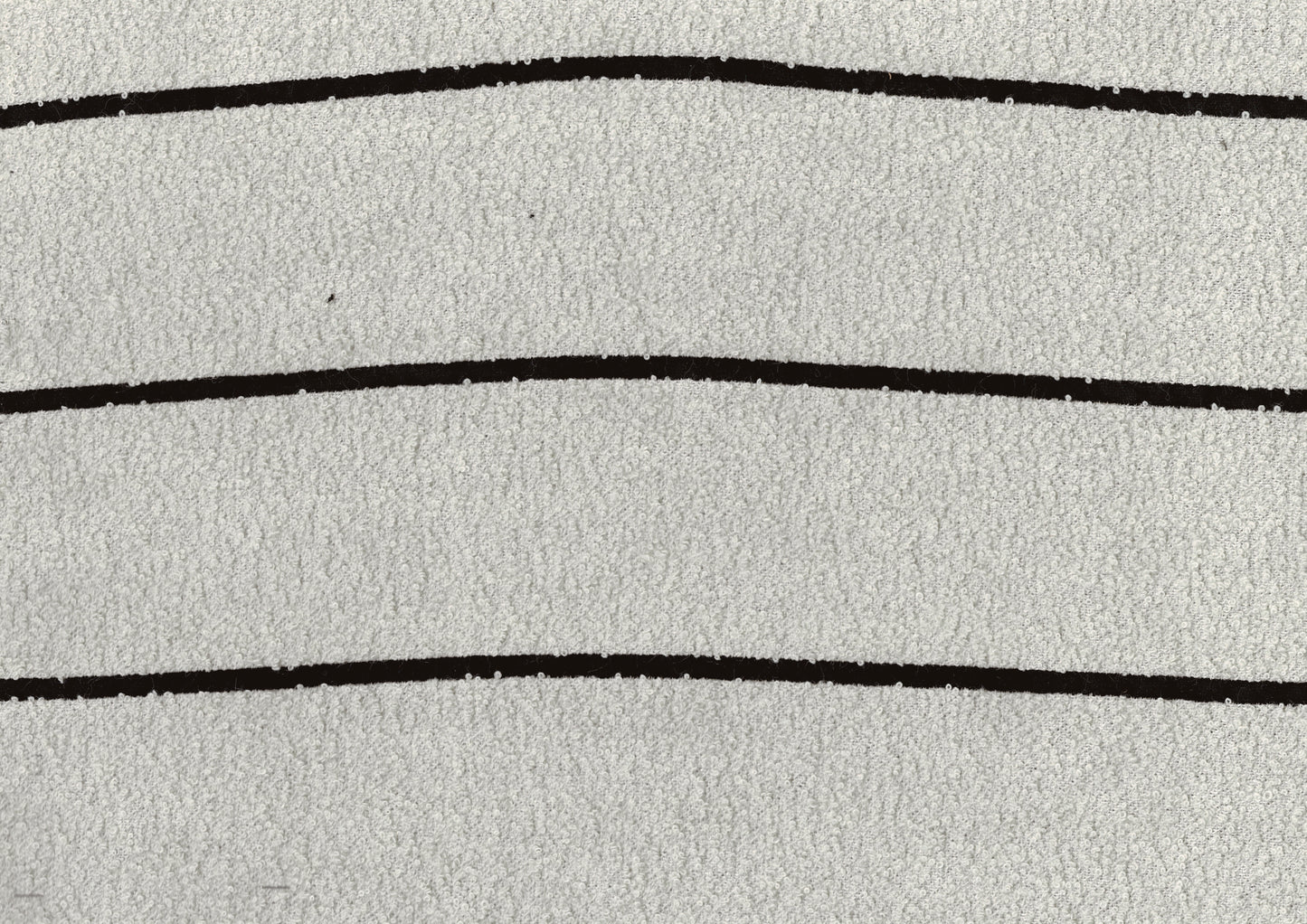 Closeup of fluffy white towel fabric with three thin black horizontal stripes