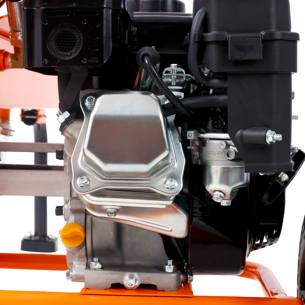 Closeup of a powerful pressure washer engine with chrome accents and a bright orange frame
