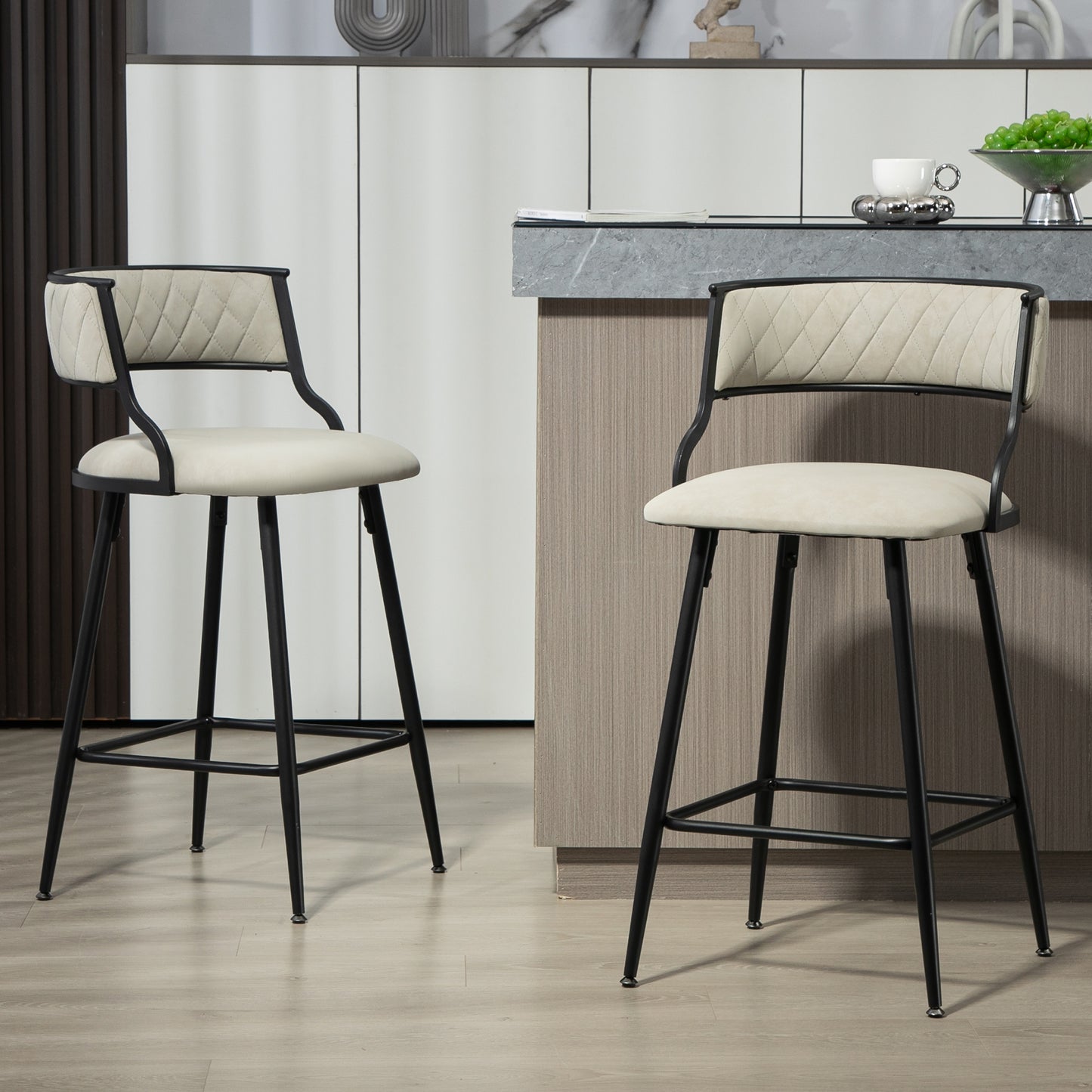 Two cream diamondstitched upholstered bar stools with black metal frames