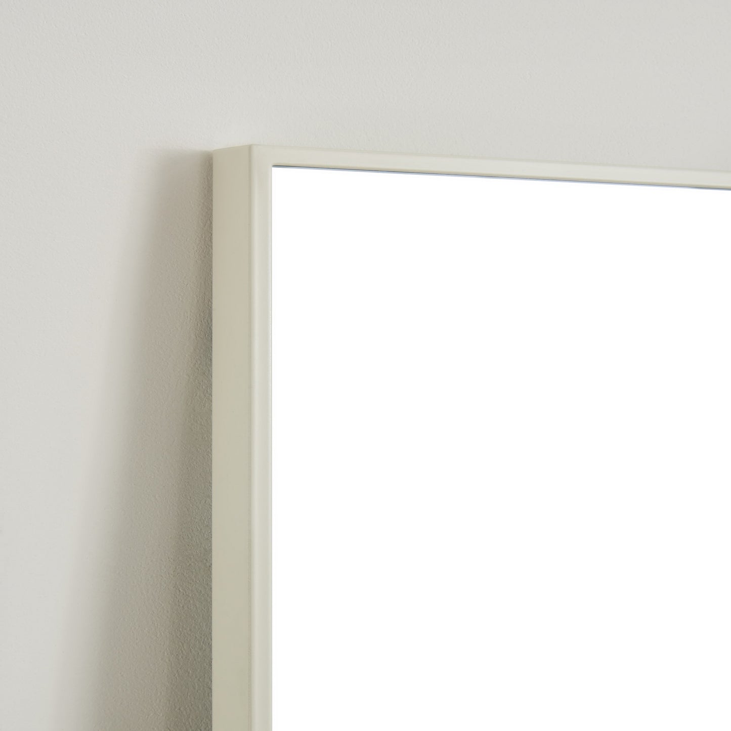 Closeup of a minimal cream frame mirror edge perfect for modern bathrooms