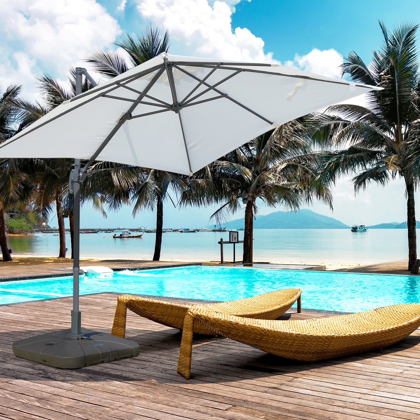 White cantilever patio umbrella providing shade over a resort pool and lounger