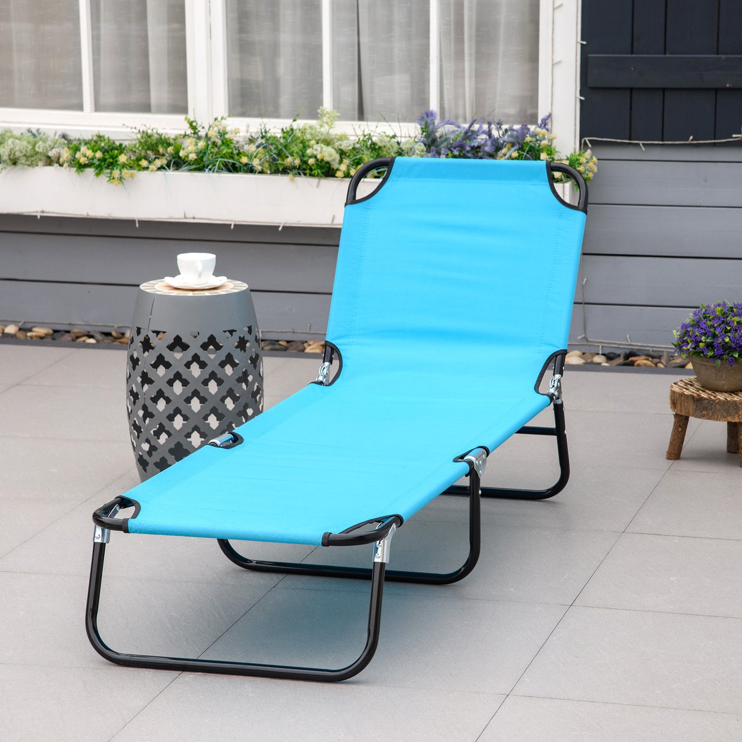 Bright blue fabric chaise lounge with black metal frame perfect for outdoor relaxation
