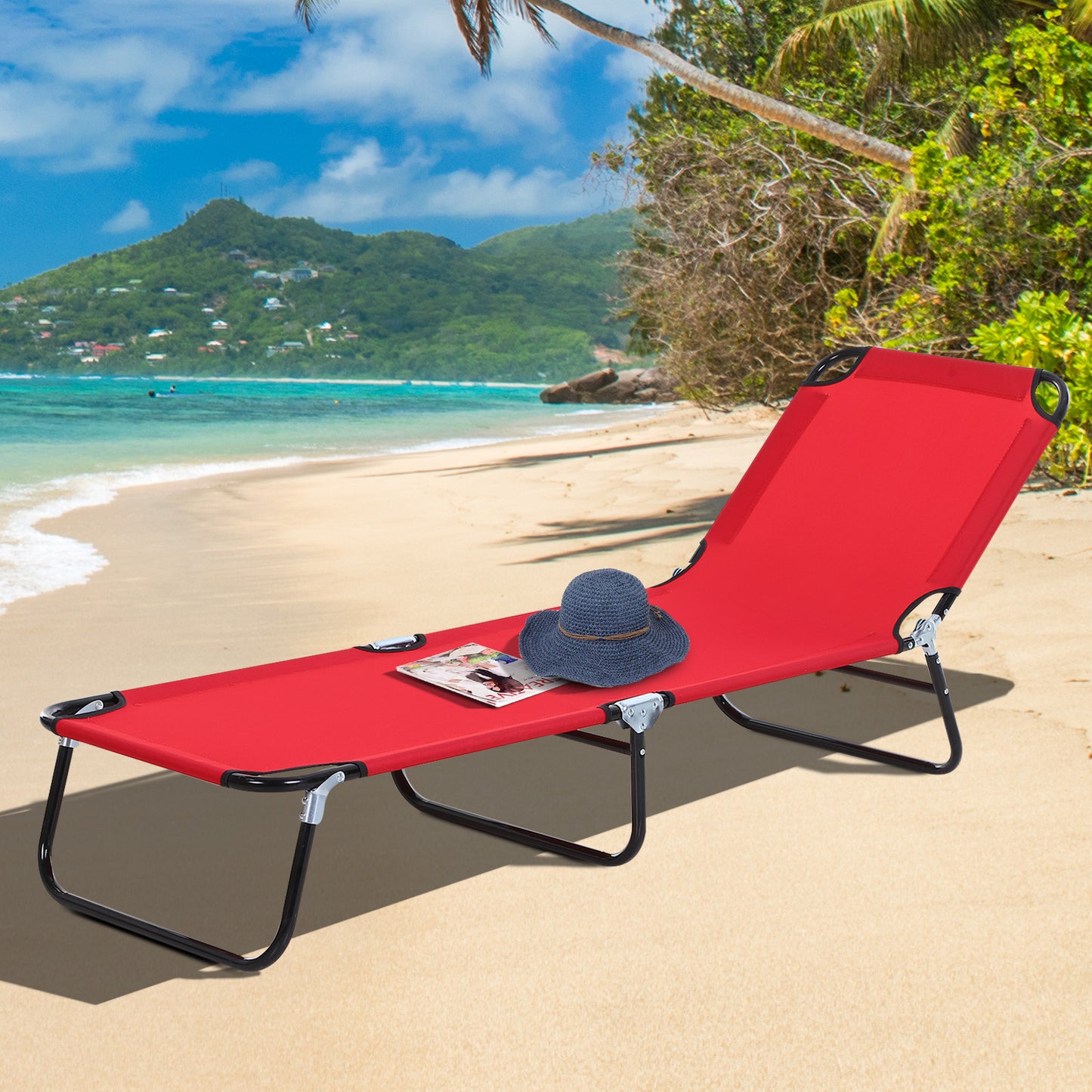 Red folding beach lounger with blue hat and magazine on sandy beach