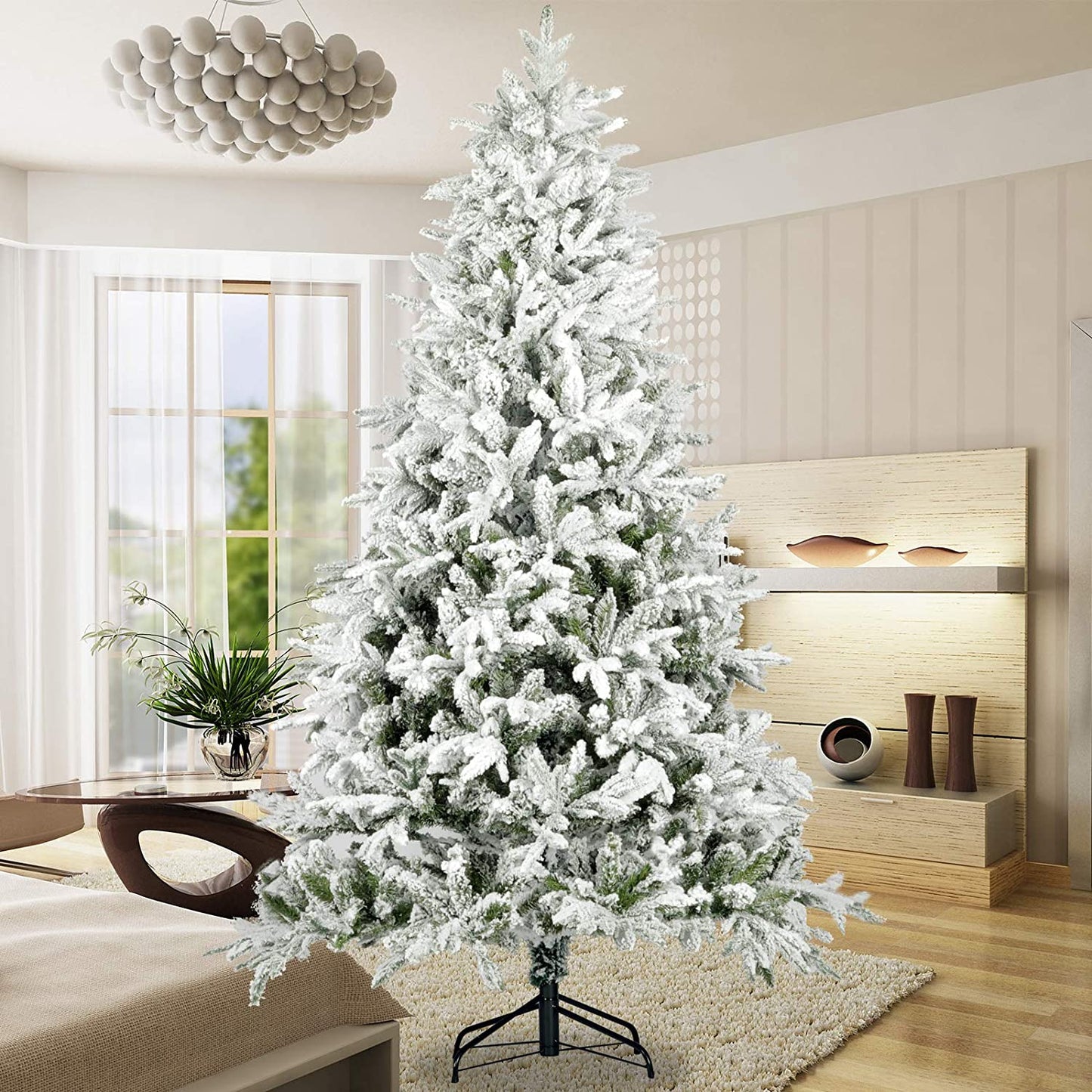 Flocked artificial Christmas tree with realistic flocked branches perfect for holiday decor