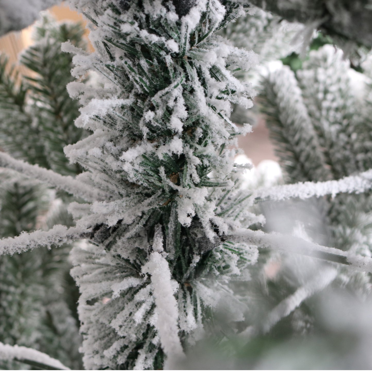 Flocked artificial Christmas tree branches with realistic snow effect