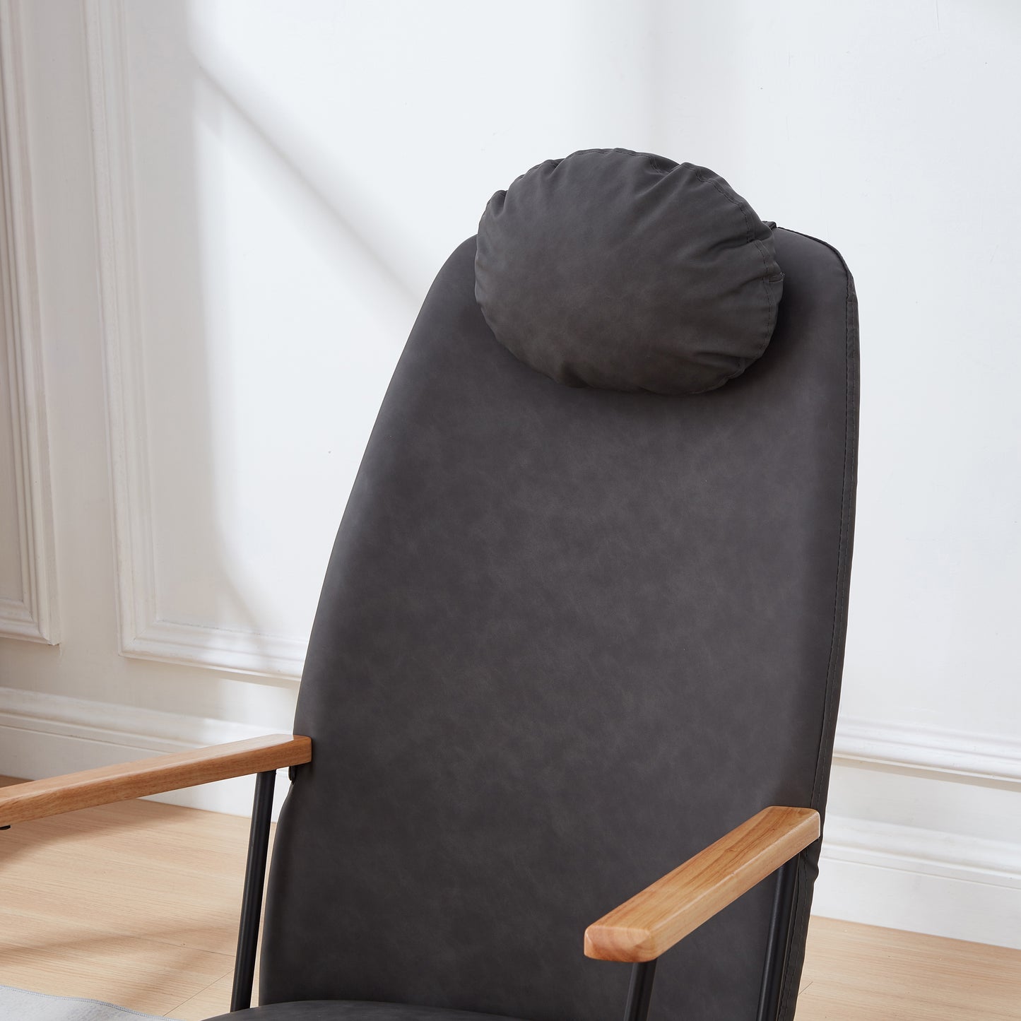 Dark gray upholstered accent chair with a plush headrest and natural wood arms