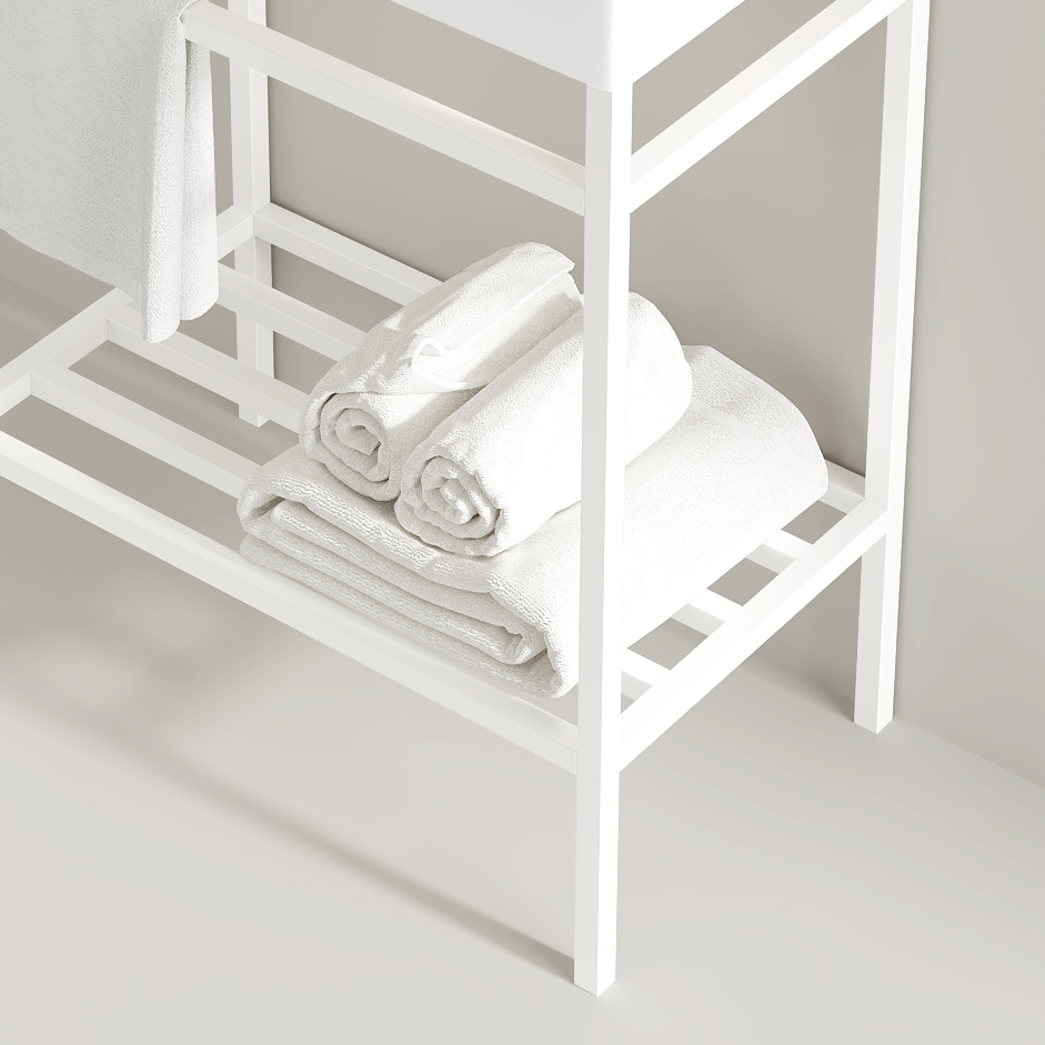 Stacked fluffy white bath towels on a minimalist white shelf