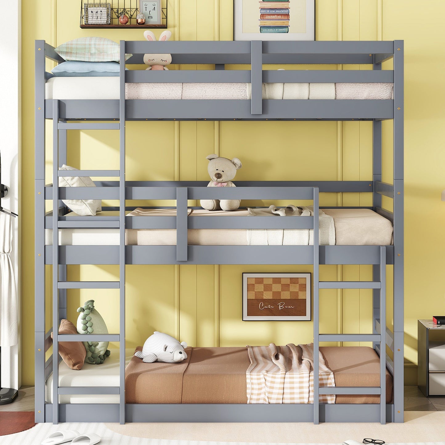 Gray triple bunk bed with mattresses and plush toys