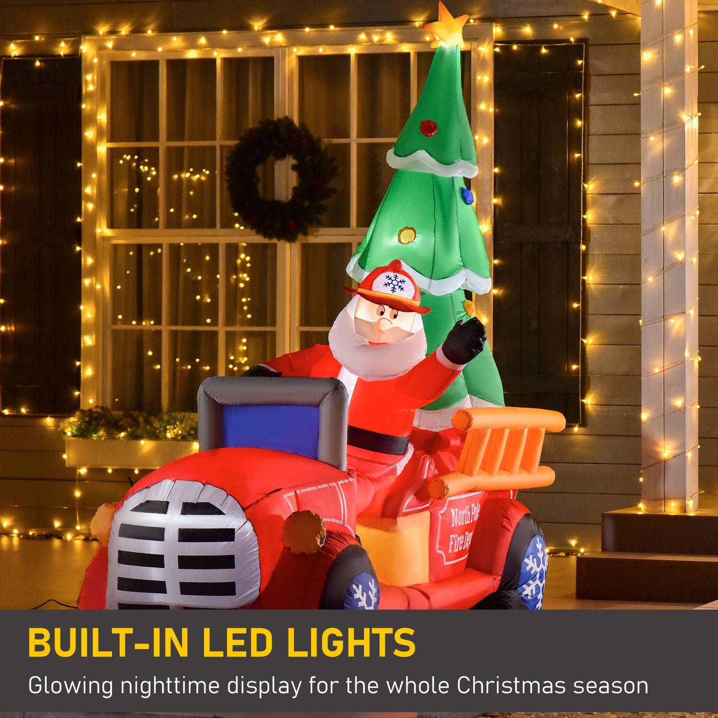 Inflatable Santa driving a red fire truck with a Christmas tree festive yard decoration