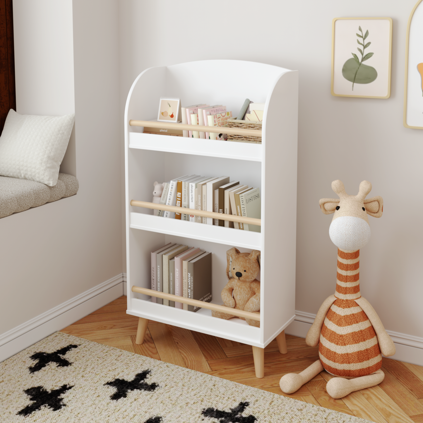 White wooden toddler bookshelf with three shelves displaying books and toys