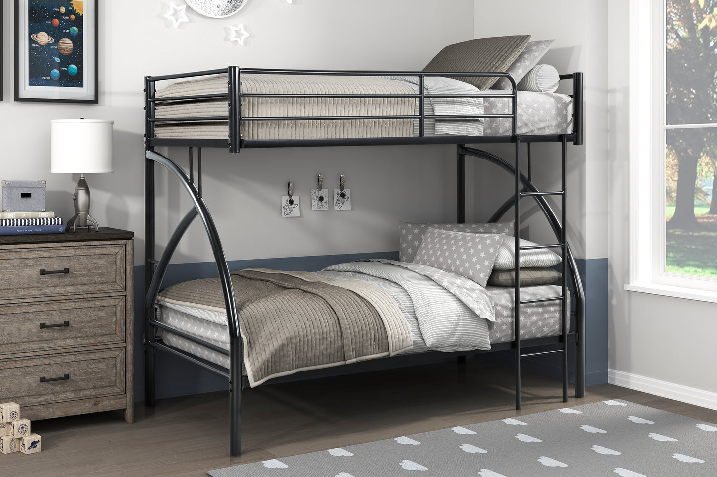 Black metal twin over twin bunk bed with starry bedding and gray quilted comforter