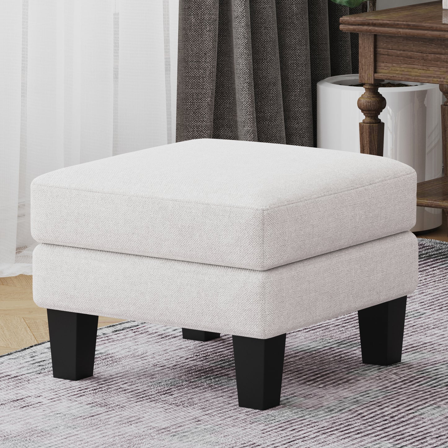 Offwhite textured fabric ottoman with four square black legs perfect for footrest