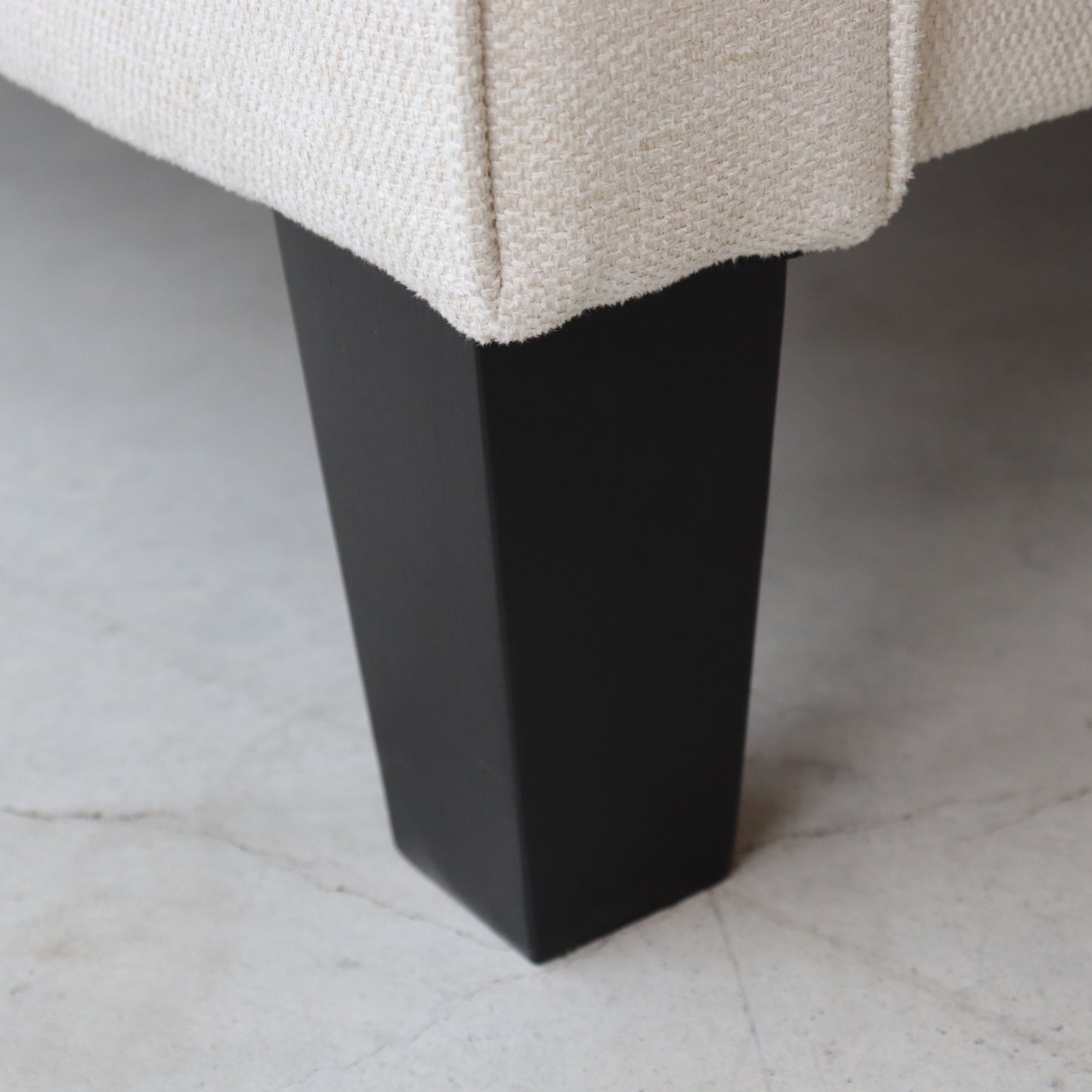 Closeup of a beige boucle fabric texture on furniture