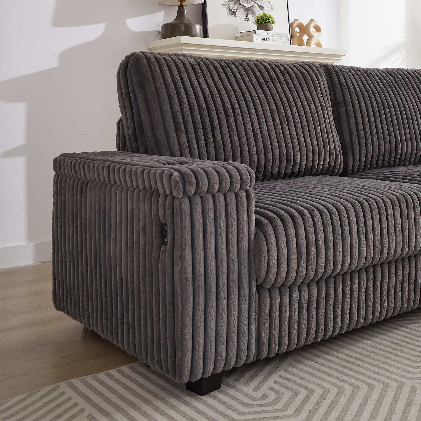 Dark gray corduroy sofa with plush fabric texture and a contemporary design