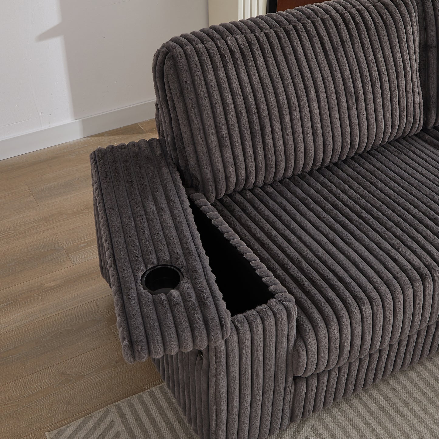 Plush grey corduroy sofa with builtin cup holder and storage console for ultimate comfort
