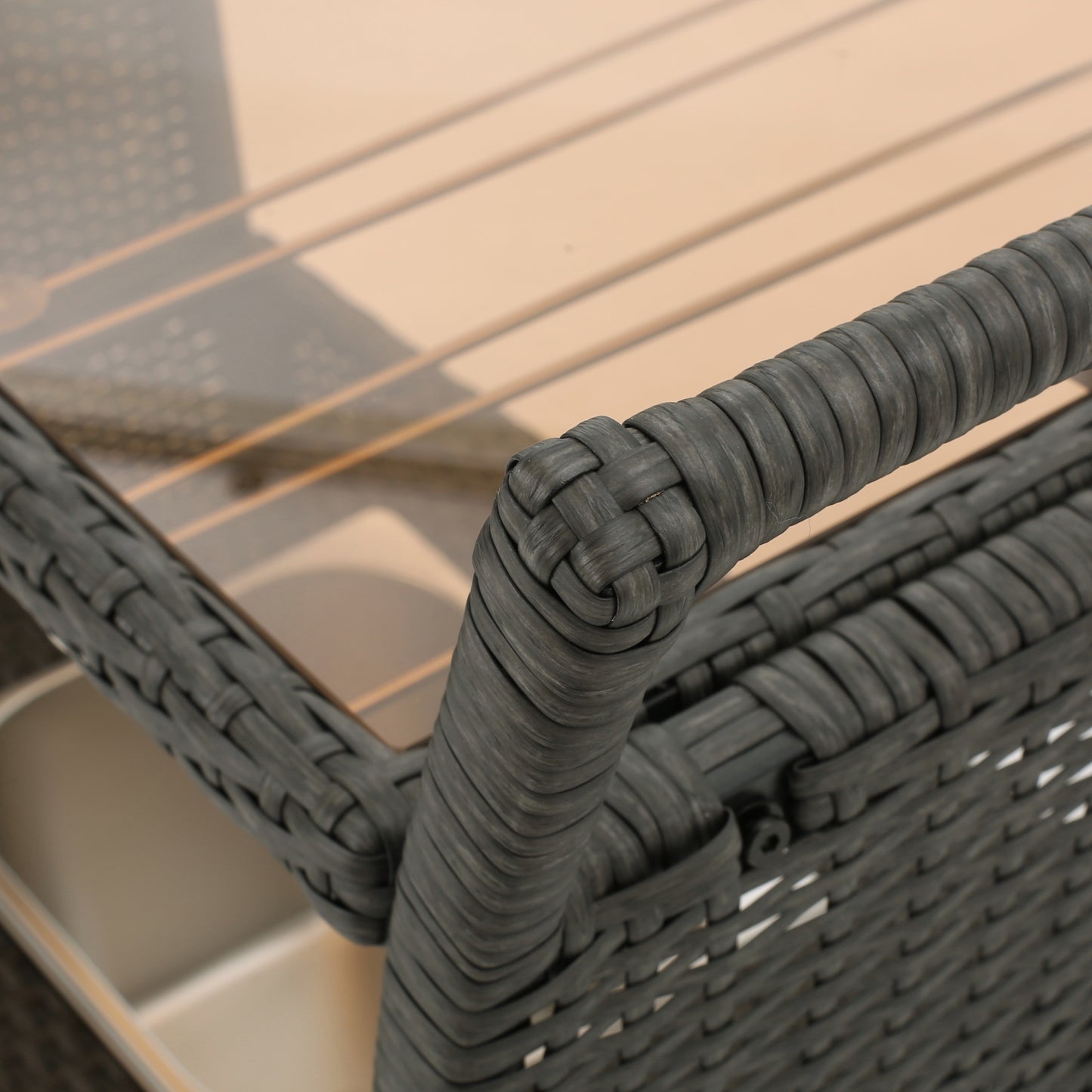 Closeup of dark grey wicker rattan furniture armrest