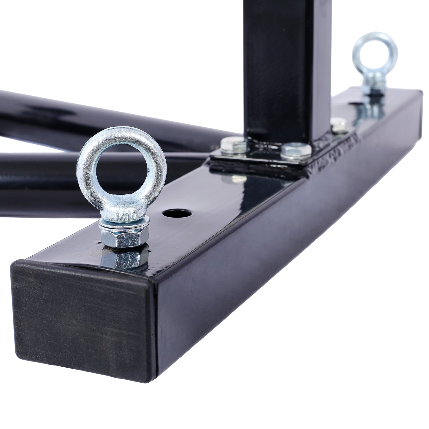 Closeup of a heavyduty steel workout equipment base with rubber feet and silver eye bolt attachments