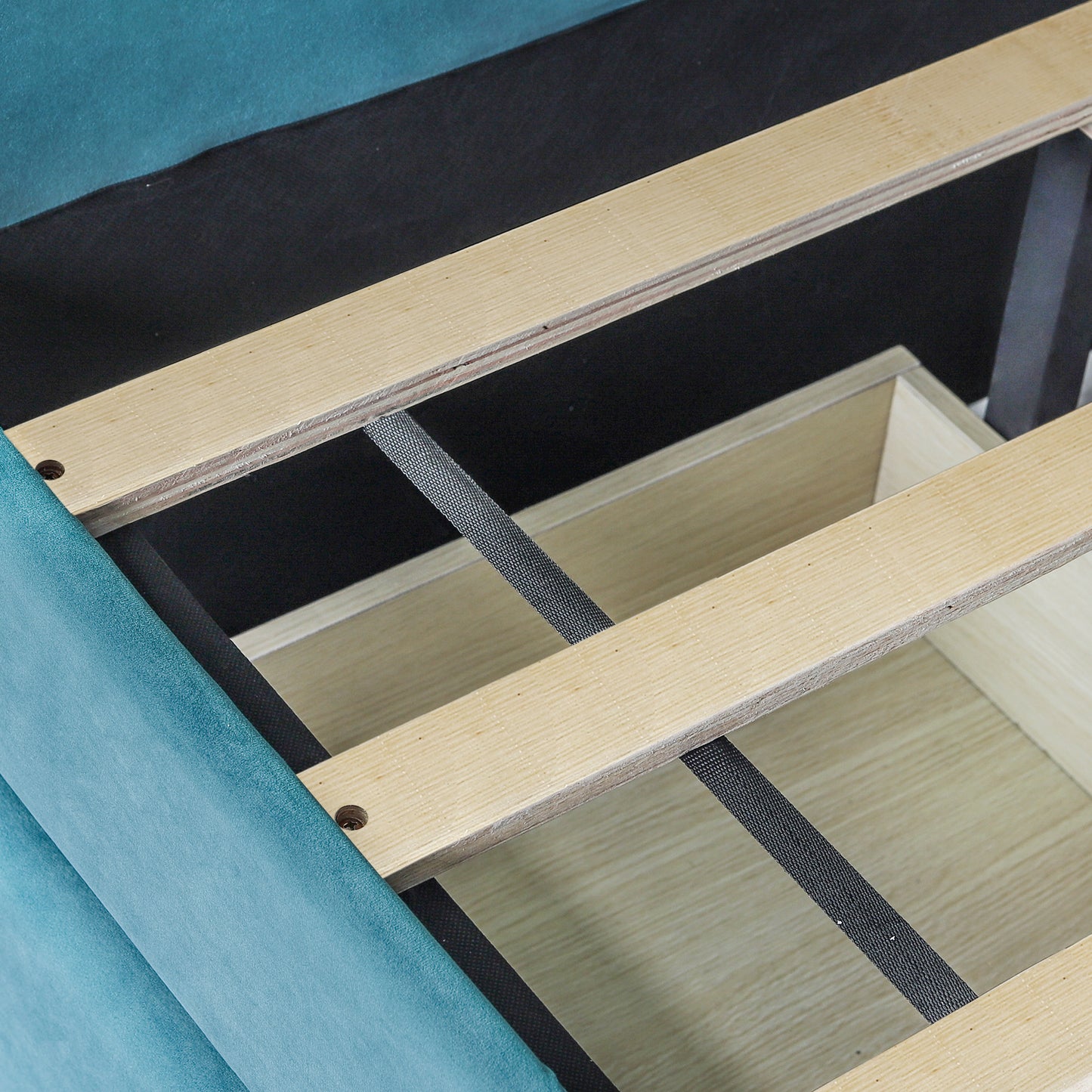 Teal velvet sofa base with internal wooden slatted support frame and storage drawer