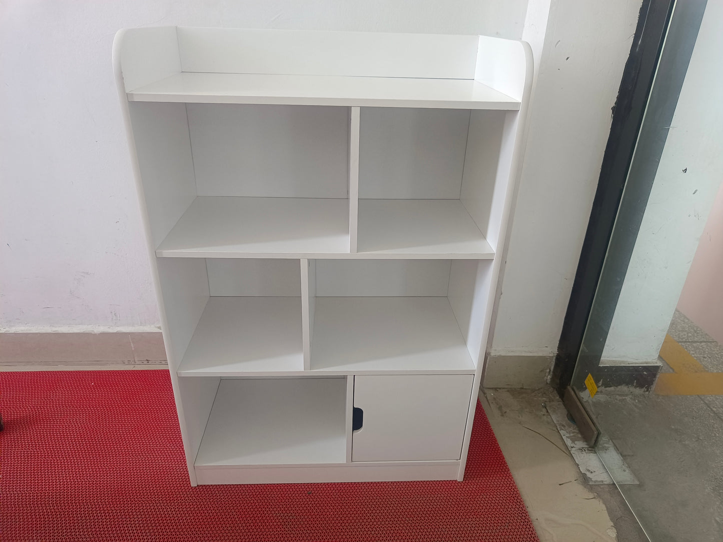 White modern bookshelf with open and closed compartments