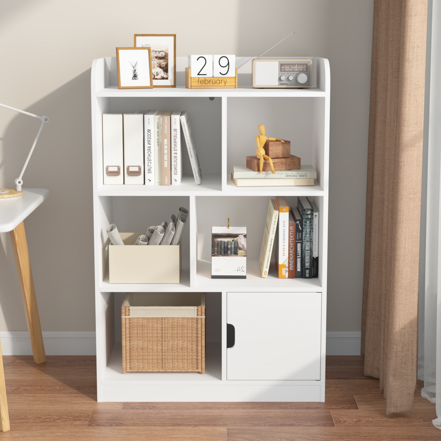 White modern bookshelf with decorative items and books displayed on shelves