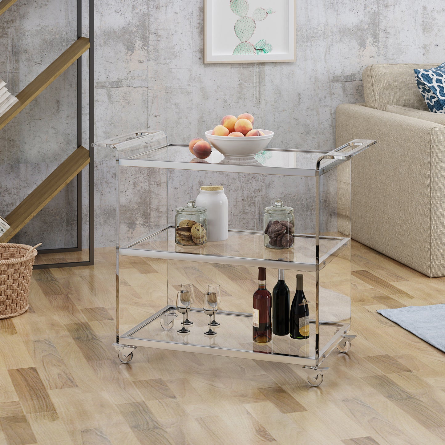 Sleek chrome and glass bar cart with wheels holding wine bottles and glasses